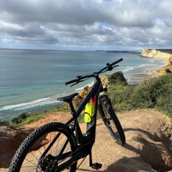 a bicycle is parked next to a body of water