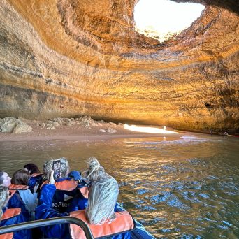 a group of people sitting on a raft in the water