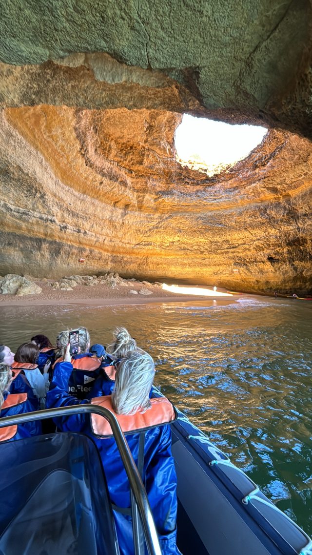 a group of people sitting on a raft in the water
